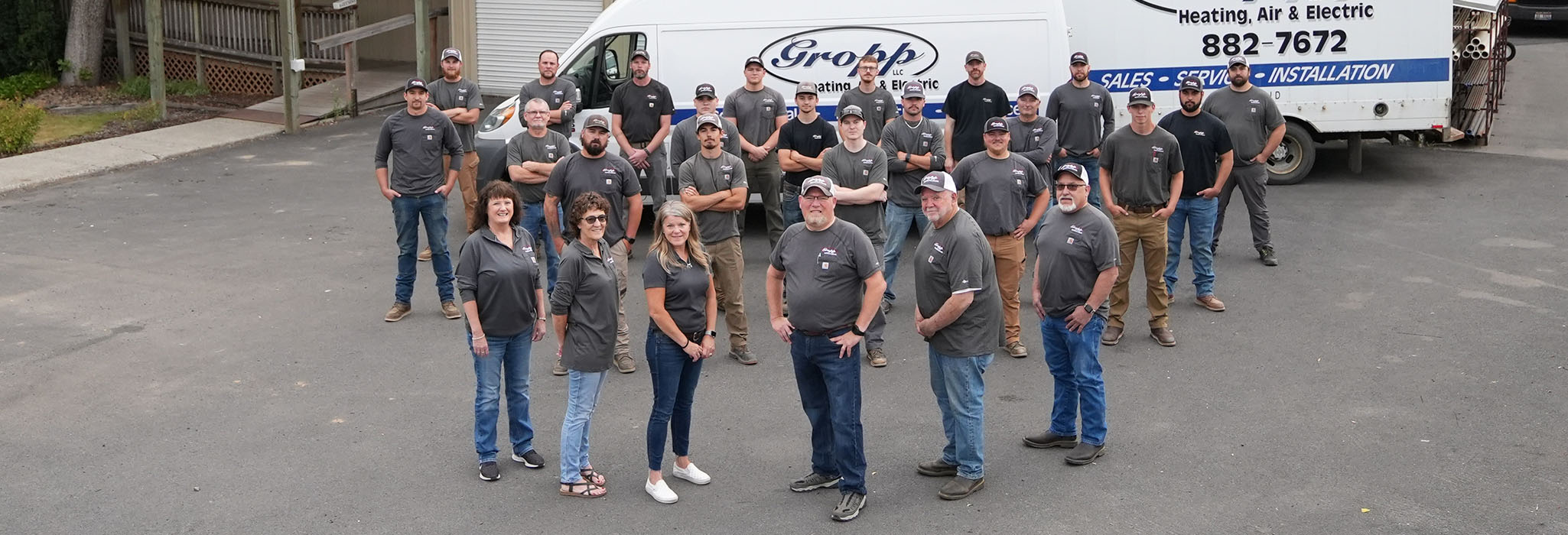 The Gropp Team standing outside of their Moscow, Idaho, office with a service truck in the background.
