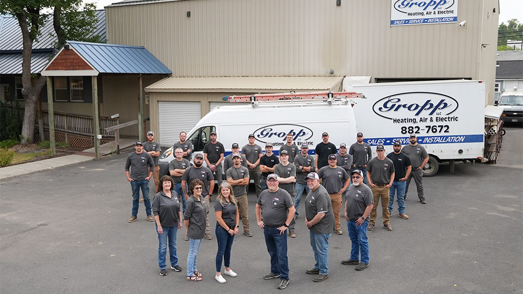 The Gropp Team standing outside of their Moscow, Idaho, office with a service truck in the background.
